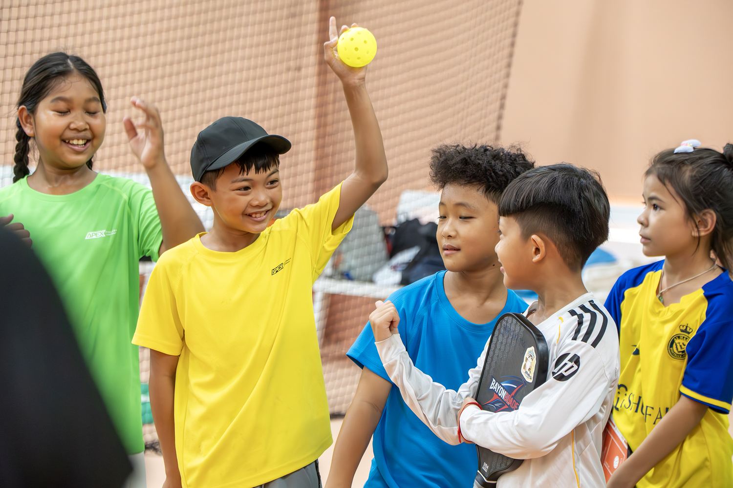 Junior players celebrating a point during an academy clinic