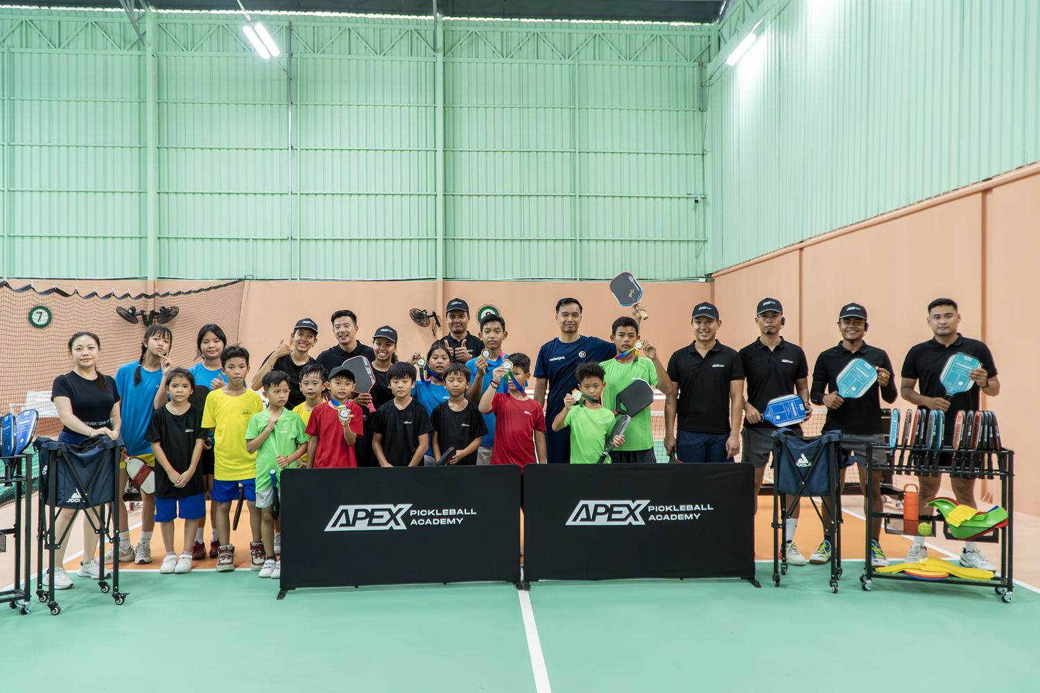 Academy players and coaches gathered on court after a session